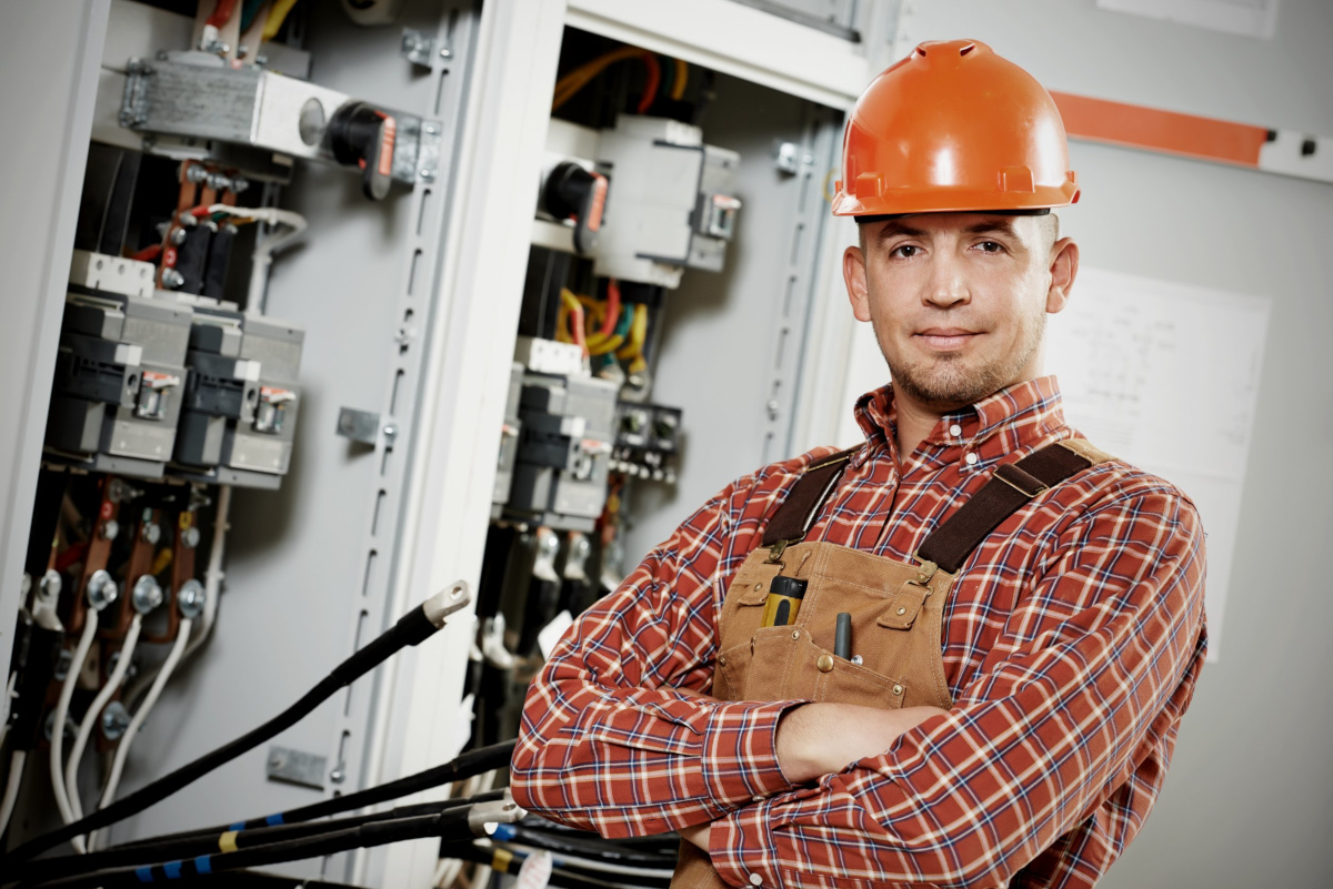 Engineer stands with arms crossed